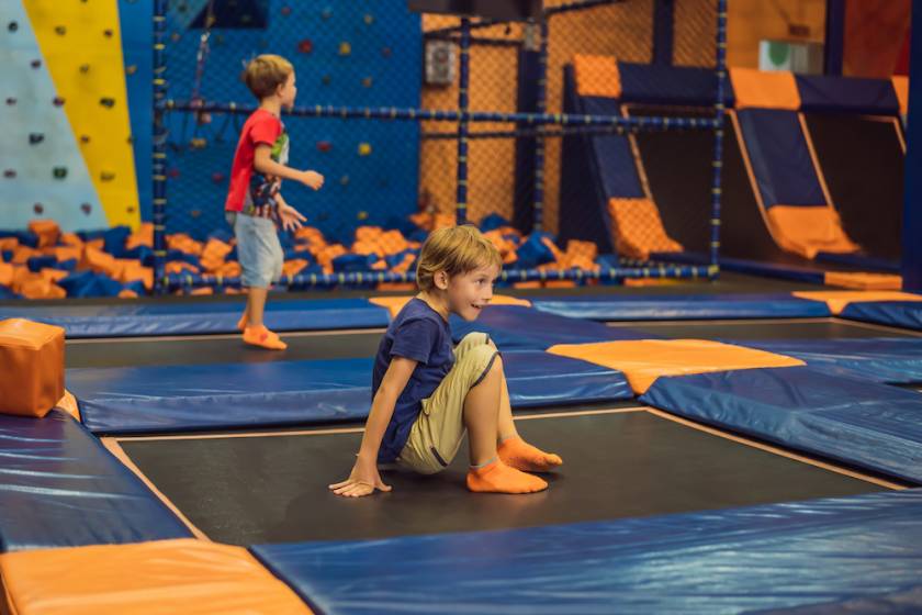 two little boys playing at an indoor trampoline park